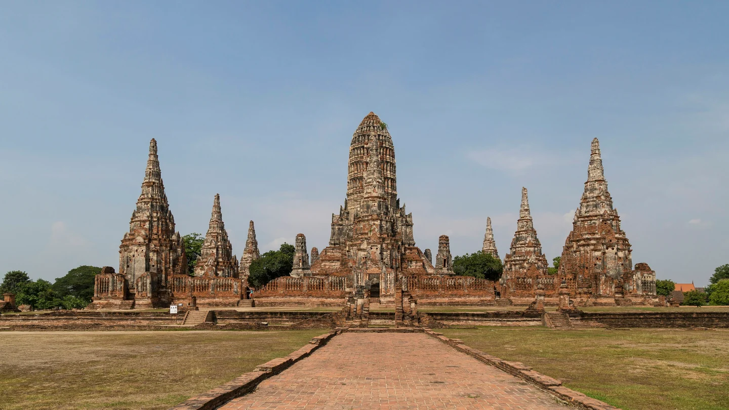 Ancient brick temple towers and a walkway in Ayutthaya